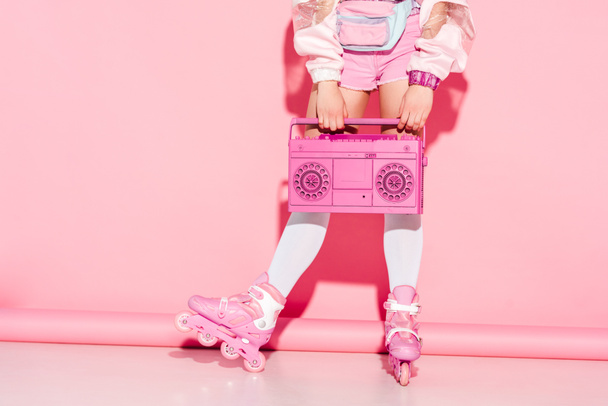 cropped view of girl in long socks holding retro boombox on pink - Foto, Imagem