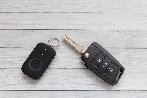 Opened Car Key with Remote Control on wooden background, close-up - Photo, Image