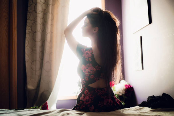 young and beautiful woman sitting on bed  - Valokuva, kuva