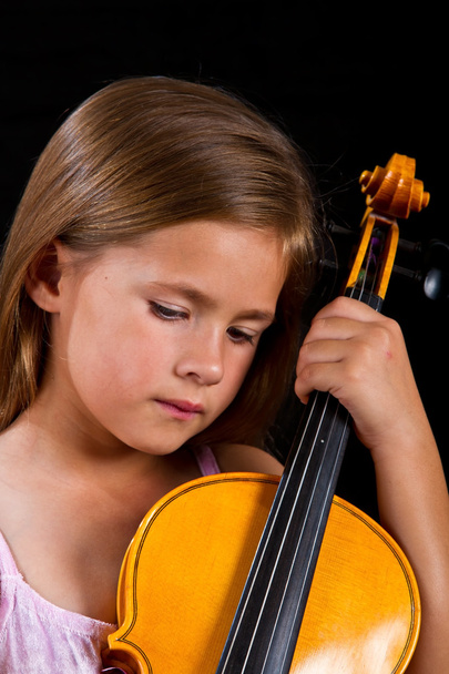 Girl holding violin in pink dress - Photo, image