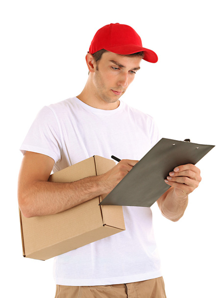 Young delivery man holding parcel and clipboard, isolated on white - Fotoğraf, Görsel