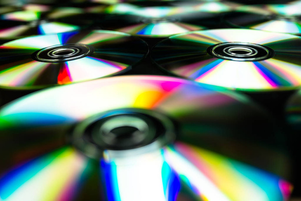 CDs / DVDs lying on a black background with reflections of light. - Photo, Image