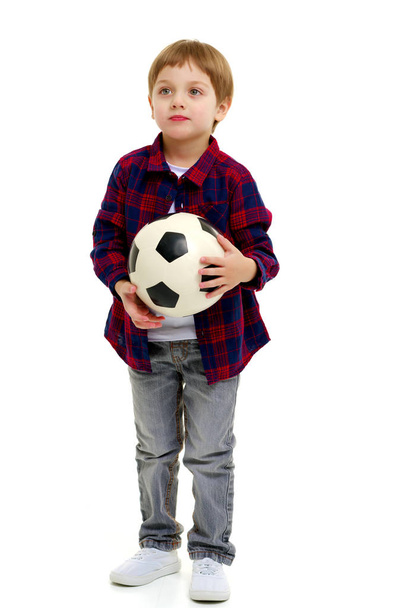 Little boy is playing with a soccer ball. - Φωτογραφία, εικόνα