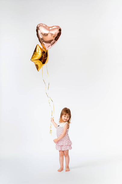 baby with heart shaped balloons and stars on white background - Foto, Bild