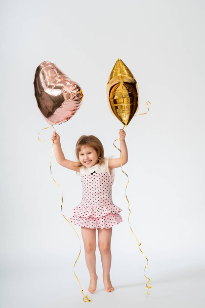 baby with heart shaped balloons and stars on white background - Valokuva, kuva