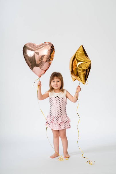 baby with heart shaped balloons and stars on white background - Fotoğraf, Görsel