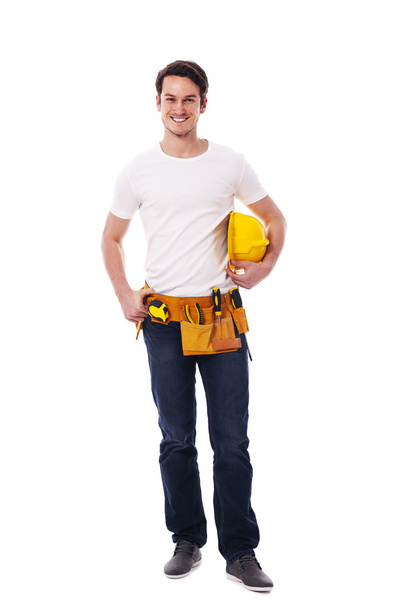 uśmiechający się robotnik trzymając kask żółty - Zdjęcie, obraz