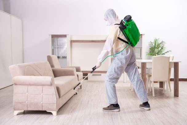 Pest control contractor working in the flat - Photo, Image