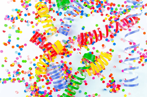 Colorful assorted confetti with serpentine on white  - Foto, Bild