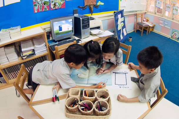 Young kids student study in classroom. - Фото, изображение
