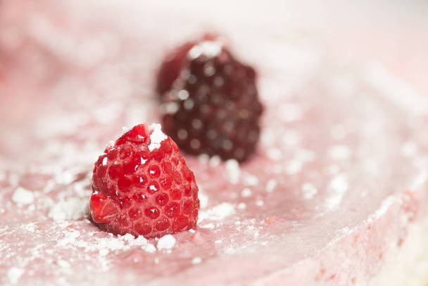 A fragment of the cake with fresh raspberries  - Zdjęcie, obraz