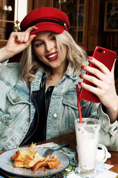 beautiful woman with blond hair in casual clothes and red hat si - Φωτογραφία, εικόνα
