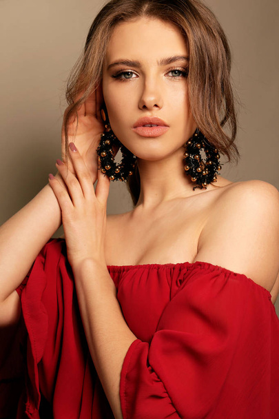 beautiful sexy woman with dark hair in elegant dress with earrin - Valokuva, kuva