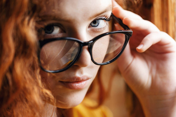 Ginger Girl Looking out of Glasses - Фото, зображення