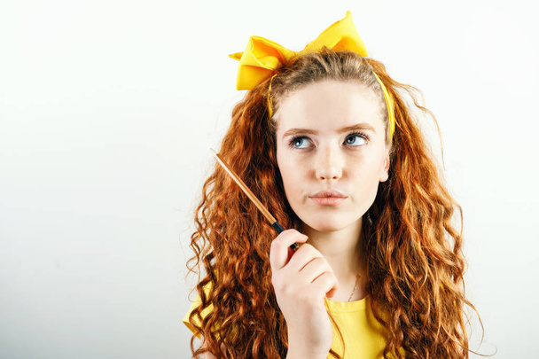Redhead Girl Holding Pencil - 写真・画像
