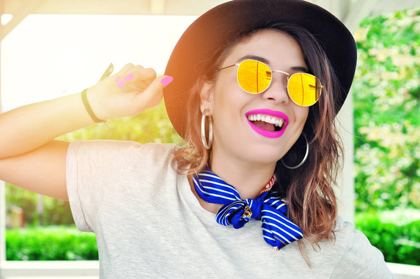 Summer city vibes. Sunny lifestyle fashion portrait pretty young smiling  woman having fun wearing trendy outfit sunglasses pink lipstick - Photo, Image