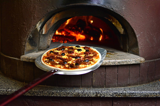 Pizza italiana prima di visitare il forno a legna
 - Foto, immagini
