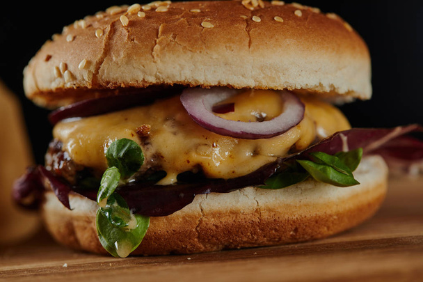 close up of delicious burger with meat, cheese and onions  - 写真・画像