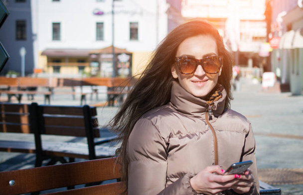 portrait of a beautiful girl of the European type with a smartphone in hand - Photo, Image