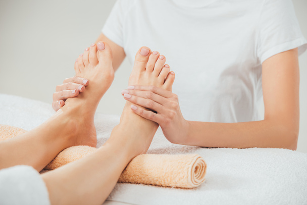 partial view of masseur doing foot massage to adult woman in spa - Φωτογραφία, εικόνα