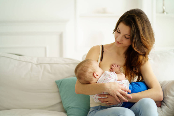 young mother breastfeeding her little son - Fotó, kép