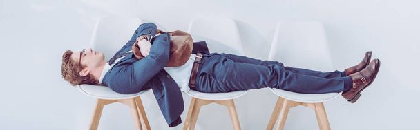 panoramic shot of employee lying on chairs while waiting job interview  - Photo, Image