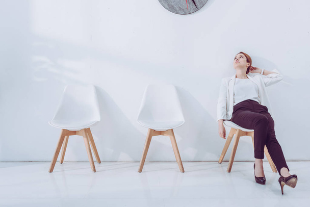 attractive employee sitting on chair and waiting job interview  - 写真・画像
