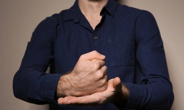 Man showing word CRUCIFY in sign language on color background, closeup - Foto, afbeelding