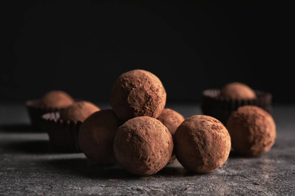 Tasty raw chocolate truffles on grey table - Photo, Image