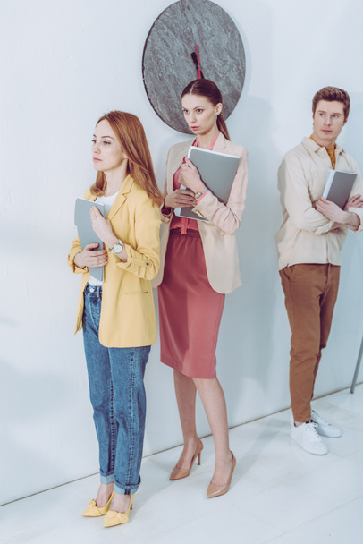 worried women and handsome man waiting in line with folders  - Fotografie, Obrázek