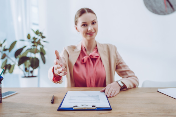 selective focus of hand of attractive recruiter sitting near clipboard  - Photo, Image