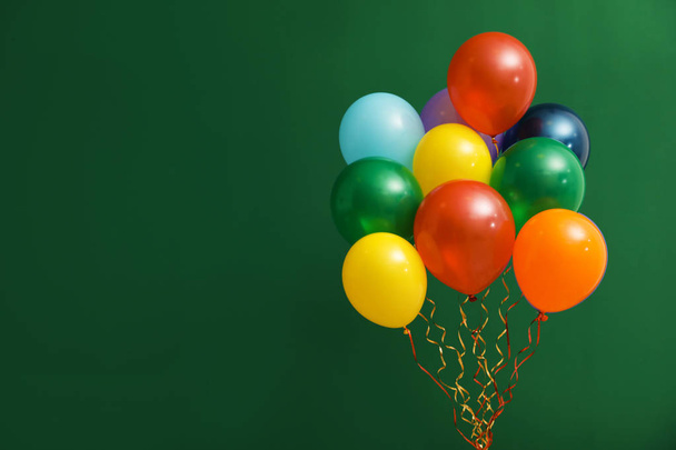 Bunch of bright balloons on color background, space for text. Celebration time - Zdjęcie, obraz