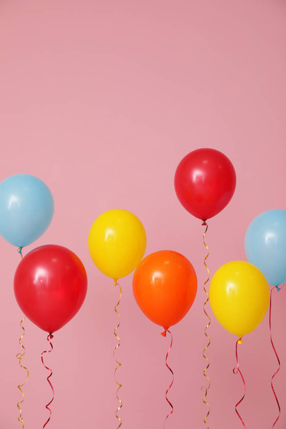 Bright balloons on color background. Celebration time - 写真・画像