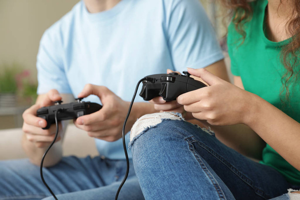 Young couple playing video games at home, closeup - Foto, Imagen