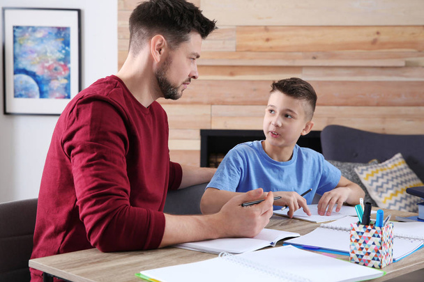 Dad helping his son with homework in room - Foto, Imagem