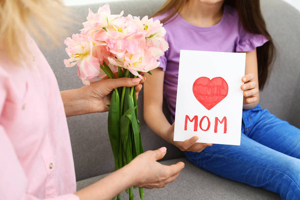 Little daughter congratulating her mature mom at home, closeup. Happy Mother's Day - Foto, imagen
