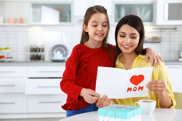 Daughter congratulating her mom in kitchen, space for text. Happy Mother's Day - Foto, Imagen