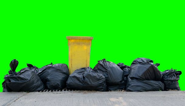 Black garbage bags on a green background - Photo, Image