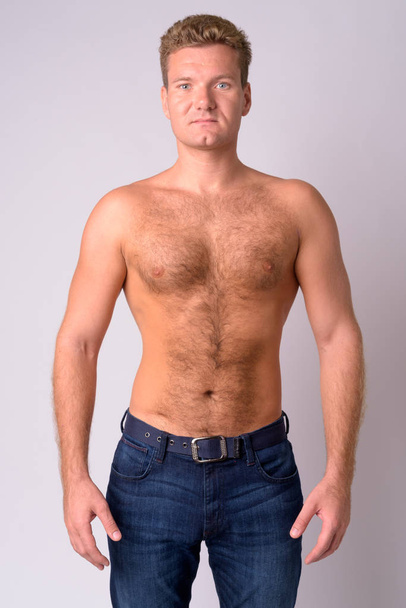 Portrait of young blonde shirtless man with chest hair looking at camera - Foto, imagen