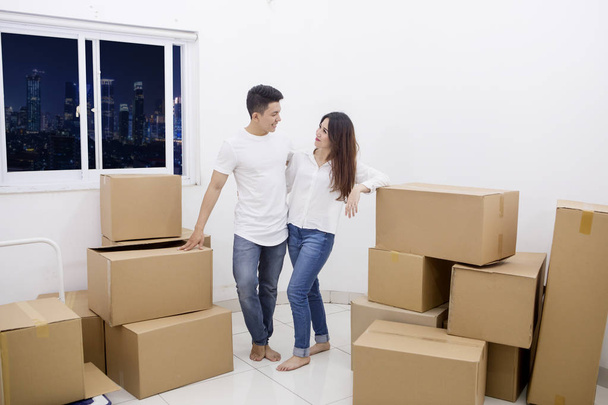 Young man embraces his wife in a new house - Photo, Image
