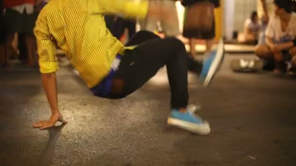 B-boy doing some breakdance moves in front a street crowd - Footage, Video