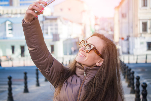 Attractive young woman taking selfie - 写真・画像
