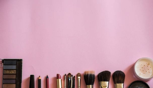 Make up brushes flatlay on pink background. Space for text. - Фото, зображення