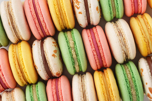 Rows of colorful french macarons. Creative background. - Fotó, kép