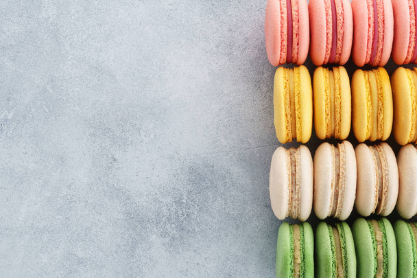 Colorful french macarons on a gray background. Top view. - Fotó, kép