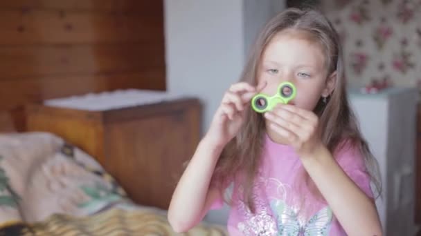 Little girl playing with spinner. - Video, Çekim