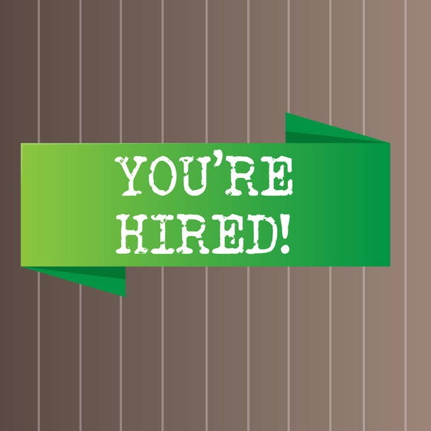 Text sign showing You Re Hired. Conceptual photo Used by huanalysis resources indicate employee that he is got job Blank Folded Color Banner photo on Vertically Striped Two Toned Backdrop. - Photo, Image