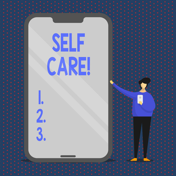 Conceptual hand writing showing Self Care. Business photo text practice of taking action preserve or improve ones own health Man Presenting Huge Smartphone while Holding Another Mobile. - Photo, Image