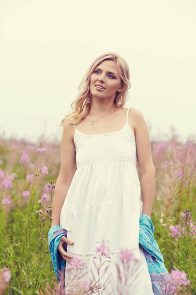 outdoor portrait of a middle aged blonde woman. attractive sexy girl in a field with flowers - Φωτογραφία, εικόνα