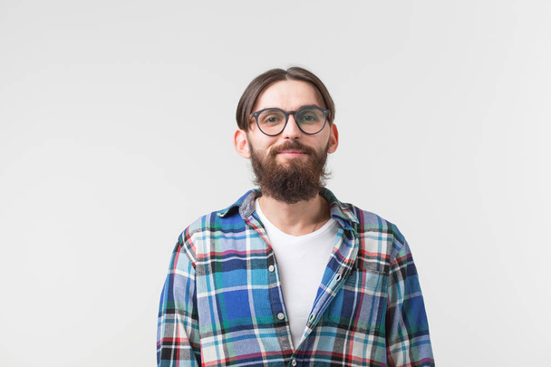 Portrait of a young bearded hipster stylish guy over white background. - Photo, Image